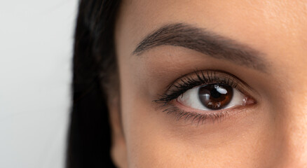 Close-up portrait of young woman with beautiful eyes. Macro cropped photo with attractive female face. Wellness, wellbeing, treatment and therapy concept