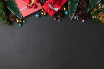 Christmas background with red gift and fir tree and decor. Top view