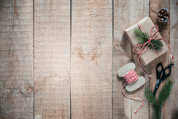 Christmas zero waste packaging gift boxes with pine cones, wooden eco decor and Christmas lights