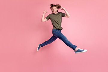 Fototapeta na wymiar Full size profile side photo of young guy happy positive smile jump run celebrate success winner isolated over pink color background