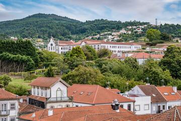 Fototapeta na wymiar Roofs of buildings in Caminha overlooking the Church and convent of Santo António with the mountain in the background, PORTUGAL