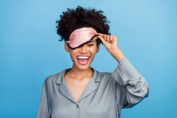 Photo of young excited afro girl have fun awakening eye mask cover eye bedroom isolated over blue color background