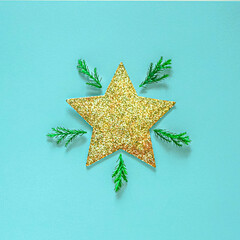 Golden christmas star on a blue background, flat lay, christmas composition