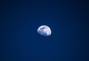 Naklejka na ściany i meble partial moon in night sky with minimalistic view alone in background