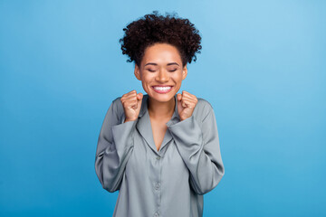 Photo of young cheerful afro girl celebrate success achievement ecstatic hooray isolated over blue...