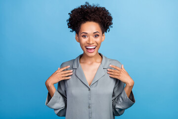 Photo of young excited african girl face reaction unexpected awakening isolated over blue color...