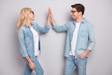 Profile side photo of young couple happy positive smile give high-five glad isolated over grey color background