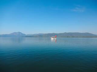 Fototapeta premium Tourist boat on a mountain lake