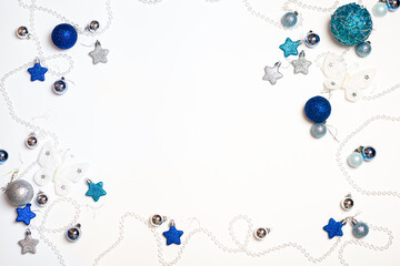 on a white background lined with silver and blue stars with a garland in the form of transparent beads, new year, background for the inscription