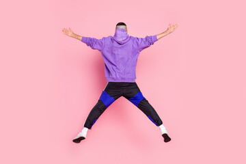 Fototapeta na wymiar Back rear view full size photo of young anonymous guy fly sporty jump isolated over pink color background