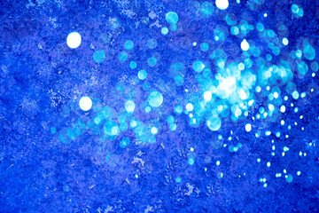 Bright blue abstract festive background with sparkles and bokeh. Christmas and New year holidays background. Festive concept