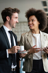 Businesswoman with male colleague discussing. Businessman and businesswomen drinking coffee