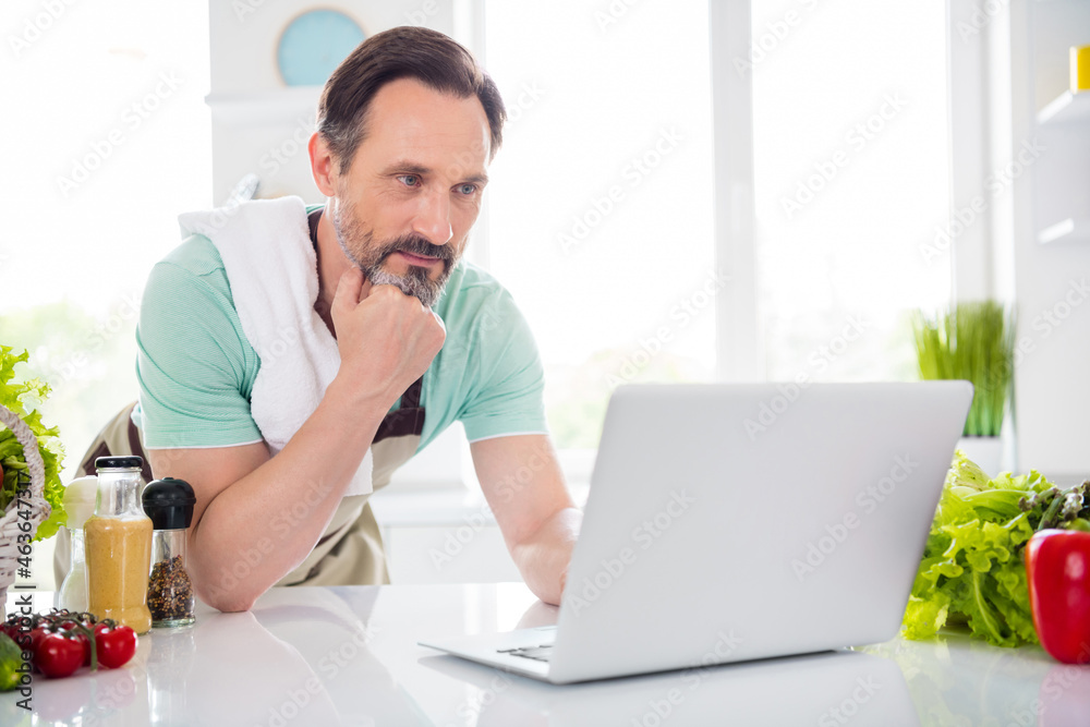 Sticker photo of focused concentrated man look screen netbook cook lesson wear apron blue t-shirt home kitch