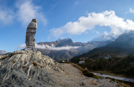 Big stone eagle sculpture on the Simplon pass in the Valais alps in Switzerland, panorama