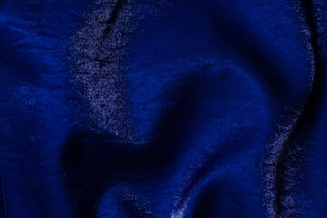 Purple shiny fabric as background. Top view.