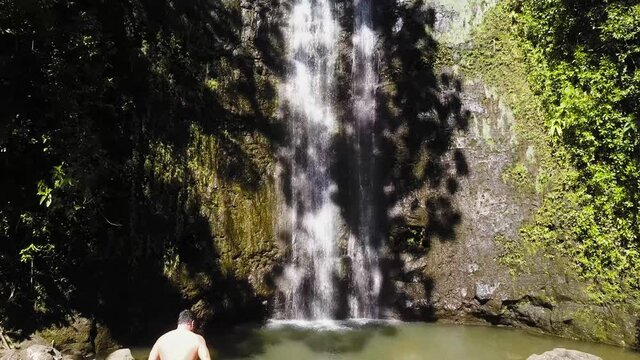 Walking up to a waterfall in Hawaii
