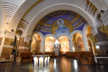 Fototapeta na wymiar Lourdes, France - 9 Oct, 2021: Religious art and architecture within the Basilica Sanctuary of Our Lady of Lourdes