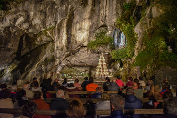Lourdes, France - 9 Oct 2021: Evening Mass service at the Massabielle Grotto, Rosary Basilica,...