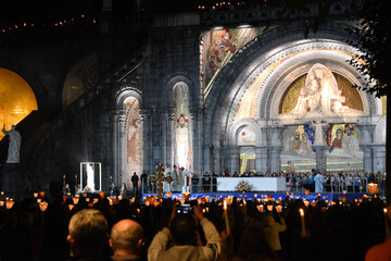 Lourdes, France - 9 Oct 2021: Pilgrims attend the Marian Torchlight Procession service at the...