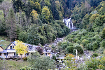 Fototapeta na wymiar Cauterets, France - 10 Oct 2021: Waterfalls cascade from the Pyrenees mountains near La Raillere springs