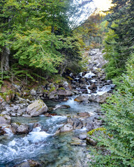 Fototapeta premium Cauterets, France - 10 Oct 2021: Waterfalls cascade from the Pyrenees mountains near La Raillere springs
