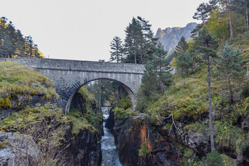 Fototapeta premium Cauterets, France - 10 Oct, 2021: The Pont d'Espagne bridge over the Gave de Marcadau in the Pyrenees National Park