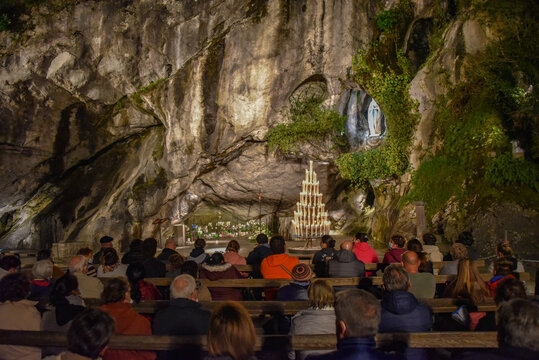 Lourdes, France - 9 Oct 2021: Evening Mass service at the Massabielle Grotto, Rosary Basilica, Lourdes