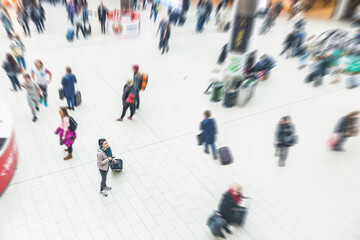 Happy woman at the airport waiting in the departure hall