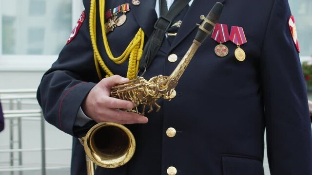 Unrecognizable trumpeters in military band on parade outdoors
