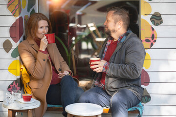 man and a woman in a cafe drinking coffee