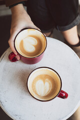 two red cups of coffee on the table