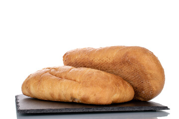 Two fragrant ciabatta on a slate stone, close-up, isolated on white.
