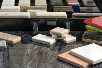 Large selection of stone samples for countertops and floors. Pieces of artificial acrylic stone in...