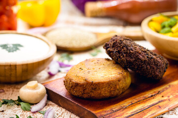 alternative burger made from black beans, vegetables, carrots, seasonings, beets, wholemeal flour and quinoa, with various vegetables.