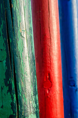 green and red and blue wooden painted logs
