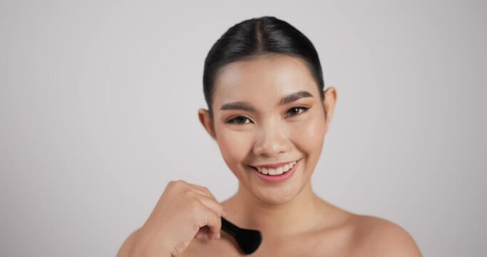 Close up of Beauty Asian woman makes makeup