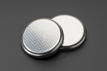 Button cell battery or coin cell isolated on black background
