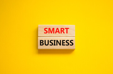 Time to smart business symbol. Wooden blocks with words 'Smart business'. Beautiful yellow background. Smart success business concept. Copy space.