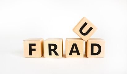 Fraud symbol. The concept word 'fraud' on wooden cubes on a beautiful white table. White background. Business and fraud concept.