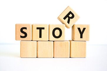 Story and storytelling symbol. The concept word 'story' on wooden cubes. Beautiful white table, white background. Business story and storytelling concept. Copy space.