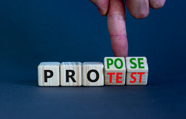 Propose instead protest symbol. Businessman turns wooden cubes, changes the word 'protest' to 'propose'. Beautiful grey table, grey background. Business, protest or propose concept. Copy space.