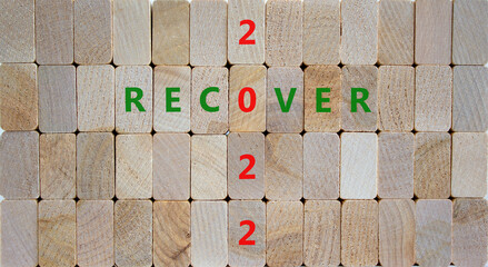 2022 recover new year symbol. Wooden blocks with words 'Recover 2022'. Beautiful wooden background, copy space. Business, 2022 recover new year concept.