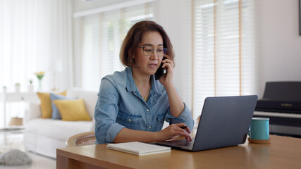 Asia adult people or SME owner woman leader moody sitting tired busy phone call work on laptop...