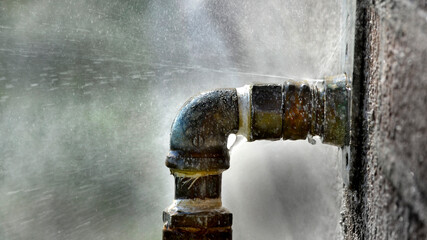 Old Leaky Pipes Squirting Water from Big Leak