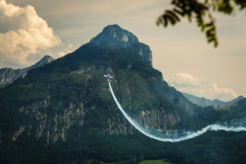 Airshow in St. Wolfgang im Salzkammergut over Wolfgangsee lake with the mountains in the...