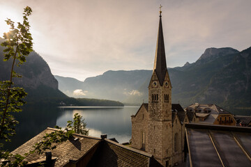 Panoramic view of famous old town Hallstatt and alpine deep blue lake in scenic sunrise light on a beautiful day in summer, Salzkammergut, Austria