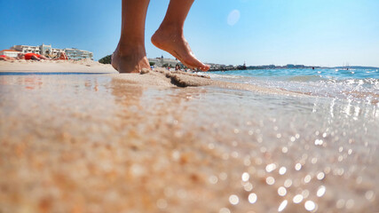 Woman walking on the Mediterranean sea coast