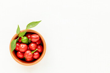 Red cherry chili top view in a bowl. White background banner