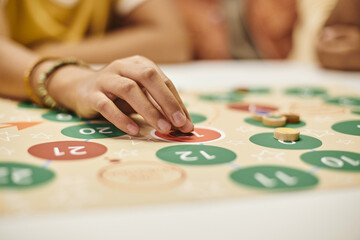 Close-up of woman playing board game at the table
