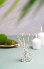 Obraz na płótnie Canvas hygge and aromatherapy concept -candles and aroma diffuser on table at home. High quality photo